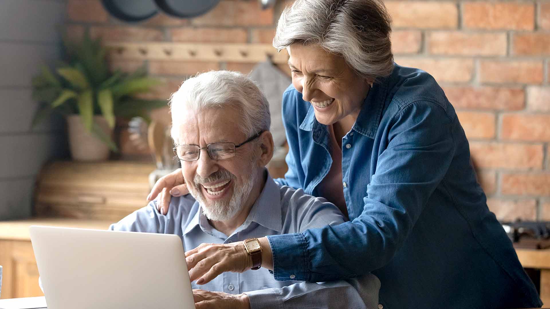 smiling couple on laptop